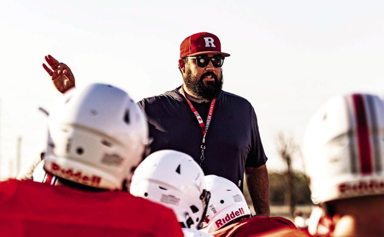 New Roby head coach/boys athletic director Zane Graves addresses the team post practice. Coach Graves arrives in Roby from Lubbock High and has also coached previously at Roscoe. This is his first year coaching at the six-man level. Photo by Mark Martinez