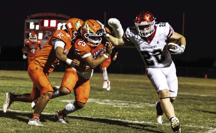 Hornet Senior Mason Brannan (right) fights off Rotan's Cristian Garcia &amp; Rhylon Lester (left) before being pushed out of bounds during Aspermont's 54-6 win over Rotan last Friday night. The win by Aspermont leveled out both team's overall records to 3-3 going into district play. The Hornets will take on the (3-3) Rule Bobcats Thursday night at 7pm in Aspermont, while the Hammers will take on the (3-2) Westbrook Wildcats Friday night at 7pm in Rotan. Photo by: Mark Martinez