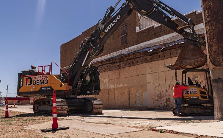 Demotion experts with Intercon began unloading equipment on Wednesday in preparation for the deconstruction of White's Hardware and Family Dollar stores that were damaged beyond repair by last summer's supercell. PHOTO BY JEFF HURT
