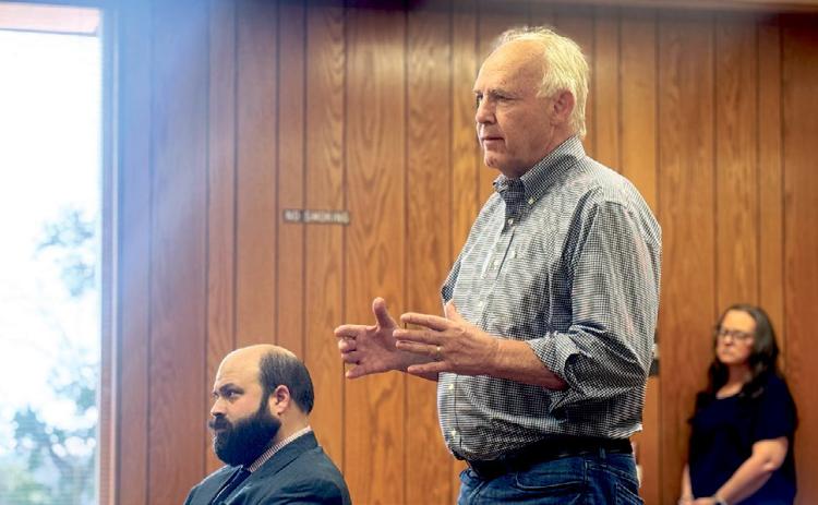 CEO of GGS Energy David Ramm explains to commissioners the request to amend the tax abatement agreement due the change in project scope as Jake Lederle (left) Fisher County’s legal counsel with Wetsel &amp; Lederle LLP later confirmed.