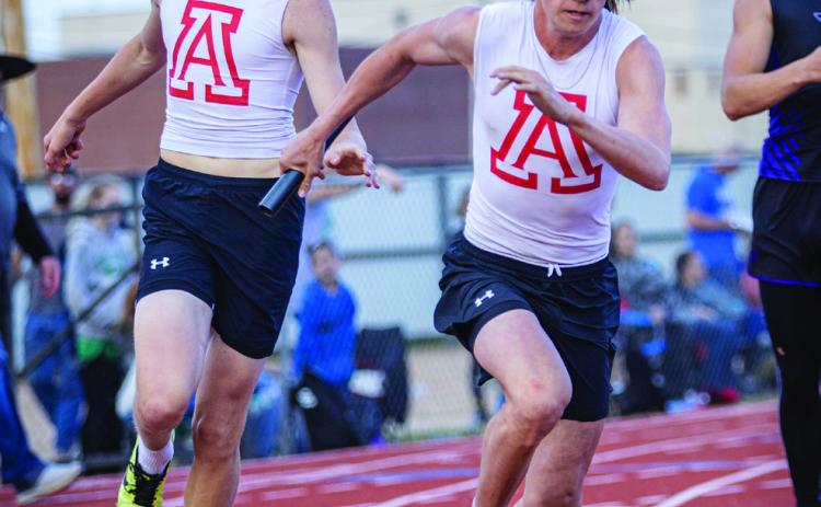 Aspermont's Sebastian Kordes handing off to Teammate Kade Morris in the 4x200m Relay. The team would finish 3rd in their heat and 5th overall in the event. Photo by: Mark Martinez