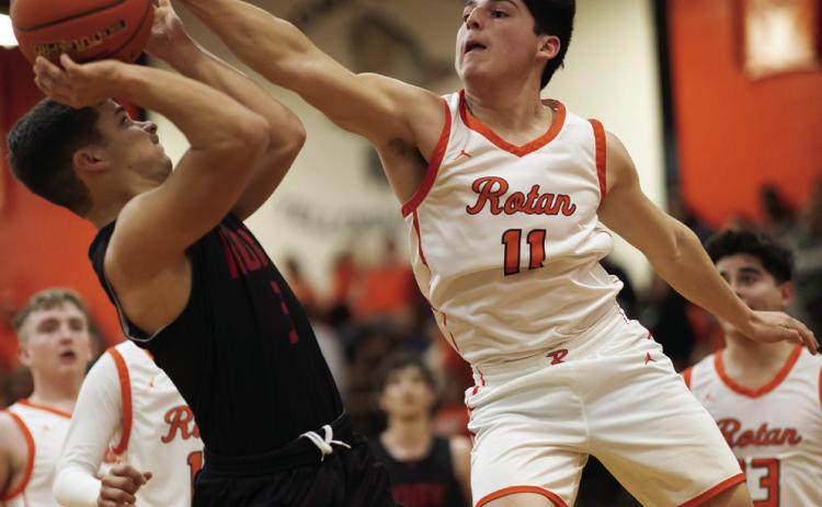 Rotan senior Juan Garza blocks a shot attempt by Roby's Dylan Lujan during the Hammers' 40-47 loss to the Lions last Friday night. Photo by Mark Martinez