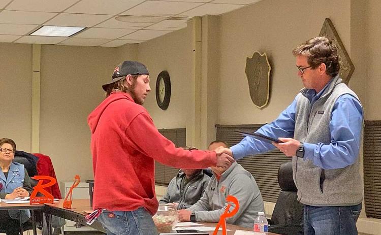 Rotan ISD Board President Britt Sipe, shakes the hand of Sam Denton who accepted his father, Rodney Denton's service award.nt Britt Sipe shakes the hand of Sam Denton who accepted his father, Rodney Denton's service award.