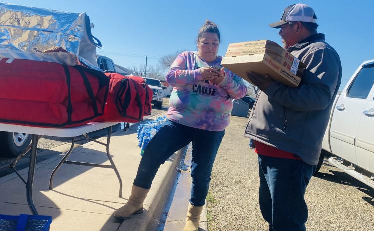 Melissa Velasquez with Cooking for a Cause out of Stamford brought in a truckload of pizzas for residents on Saturday. Aspermont City Manager Lorenzo Calamaco picked up a few slices to deliver to remote crews who were still working to repair the city’s water line. (Photo by Everleigh Hurt -1st Grader Rotan ISD)