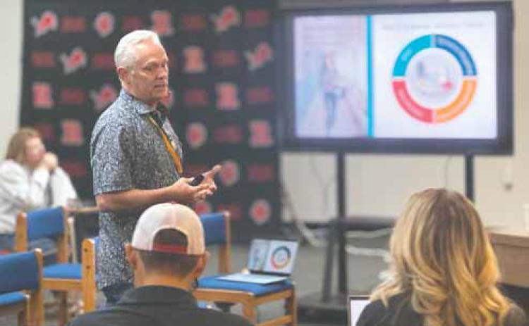 Rick Hoover, a re_red school safety director with Five Stone Safety, briefs Roby CISD trustees on the district’s new panic alert system during last week’s regular mee_ng. The system will bring the district into compliance with state-mandated safety requirements under Alyssa’s Law.