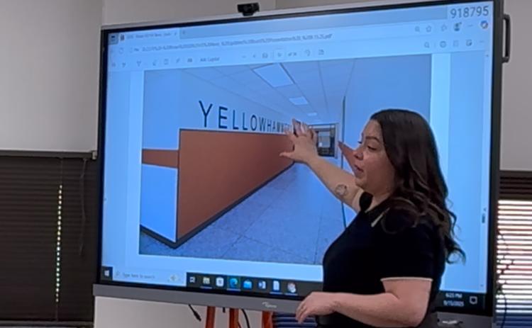 WRA Architects project coordinator Monica Castillo shows Rotan ISD trustees examples of proposed interior finishes during the Sept. 16 board meeting.