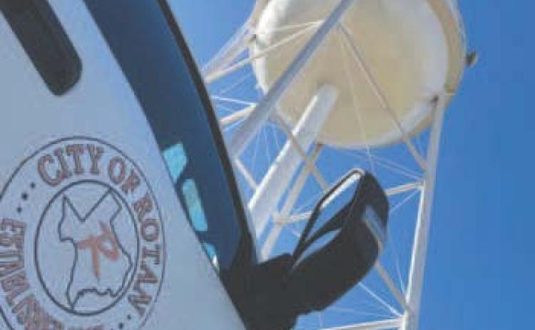 A view from alongside a city work truck shows the recently completed restoration of Rotan’s North Water Tower, freshly repainted and standing against the Autumn skyline.