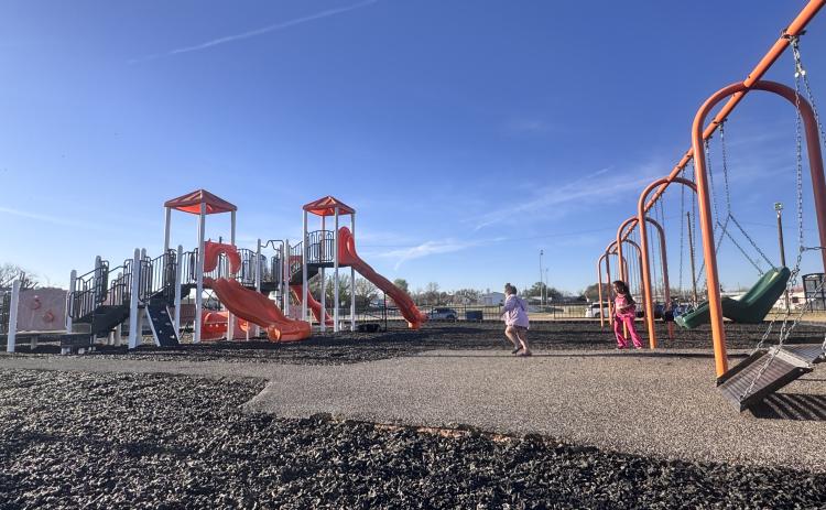 Children play on the newly installed rubberized mulch at the Rotan city park this week. The upgraded surface replaces older wood chips and is expected to provide a more durable play area.