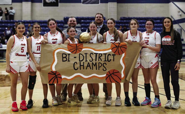 The Rotan Lady Hammers and their coaching staff with the Bi-District title after defeating Munday 38-32. Photo by: Mark Martinez