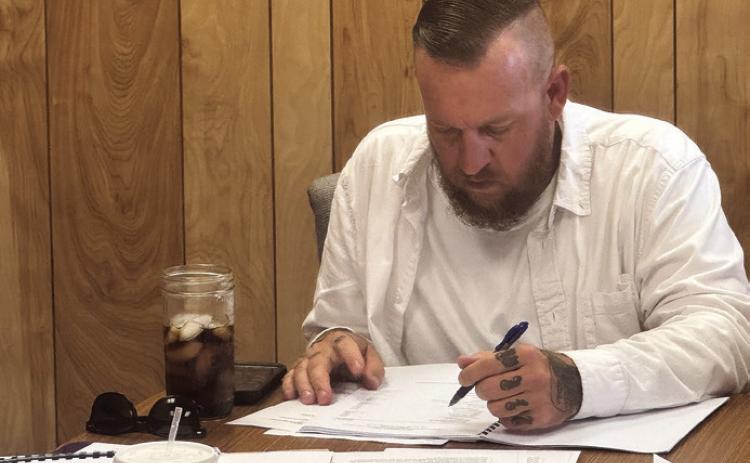 Aspermont Mayor Steven Ellis follows along while the council reviewed the city’s annual financial report, showing that while some losses were realized, the city remains on solid financial ground. PHOTO BY JEFF HURT