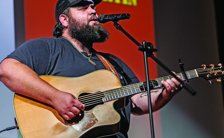 Jeff Martin from Albany bangs out the melody on guitar while delivering his rendition of Brooks and Dunn's, 'Old Man Wrigley,' taking the $500 grand prize during Stonewall Living Center's talent showcase last Friday. (PHOTO BY TRICIA HURT)