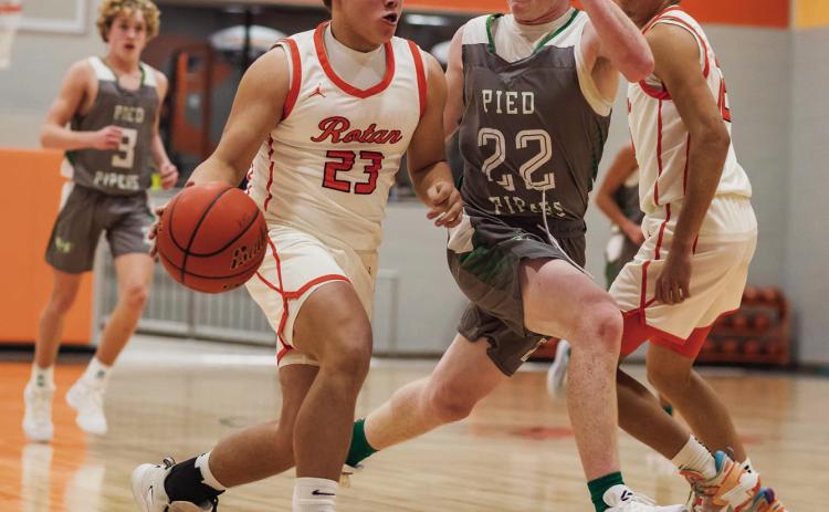 Sophomore Rhlyon Lester fast breaks to the basket pursued by a Piper defender during the Hammers 36-70 loss to Hamlin Tuesday night. PHOTO BY MARK MARTINEZ
