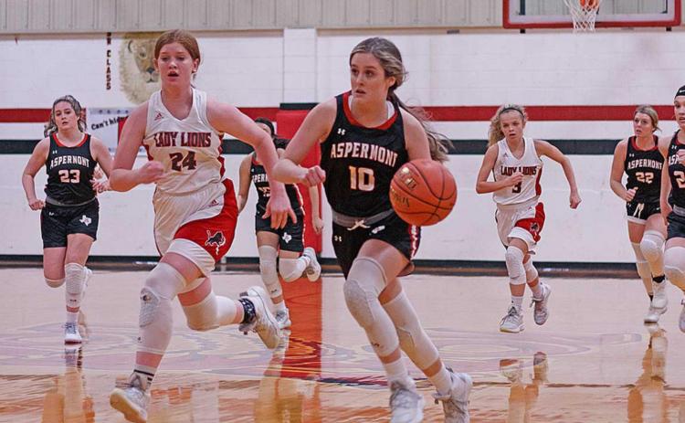 Lady Hornet, Sadie Gentry fast breaks down the court being pursued by Lady Lion, Laney Stuart (Photo by Mark Martinez)