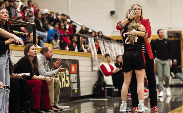 Aspermont's Coach Pott's hugs Senior Shelby Martin as the end of the final playoff game of the season