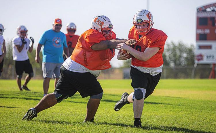 Rotan freshman Jayden Louis tags senior Michael Moffett during a drill.