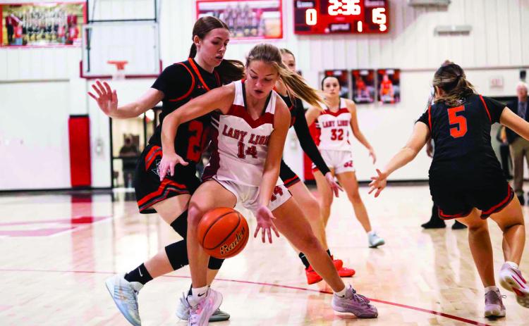 Roby's Berklee Lummus fights through a Lady Bulldog defender to reach to reach the basket. Photo by: Mark Martinez