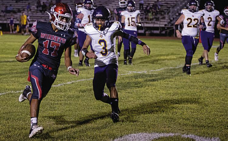 Aspermont senior Calob Castaneda slips by Bulldog defenders to score during last Friday's 56-8 win over Moran. Photo by: Mark Martinez