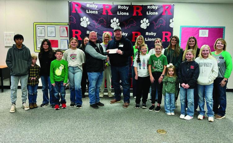 Roby CISD Superintendent Kenny Border joins students and staff to accept the $2,500 donation from Clearway Energy/Mesquite Star LLC as part of the company's Adopt a School