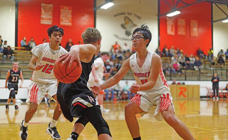 Rotan's Johnny Lujan (left) &amp; Cody Means ( right) work to contain the Raider offense. Photo by: Mark Martinez
