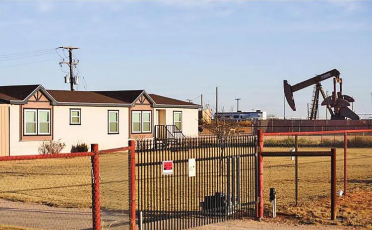 A pumpjack next to a home in Gardendale. Texas is the nation’s top natural gas producer but the state has started exporting more of it to other countries, which contributes to rising utility costs for Texans. Credit: Eli Hartman for The Texas Tribune