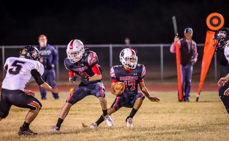 Aspermont Hornet, Caleb Castaneda prepares to make a cut to avoid Bulldog defenders