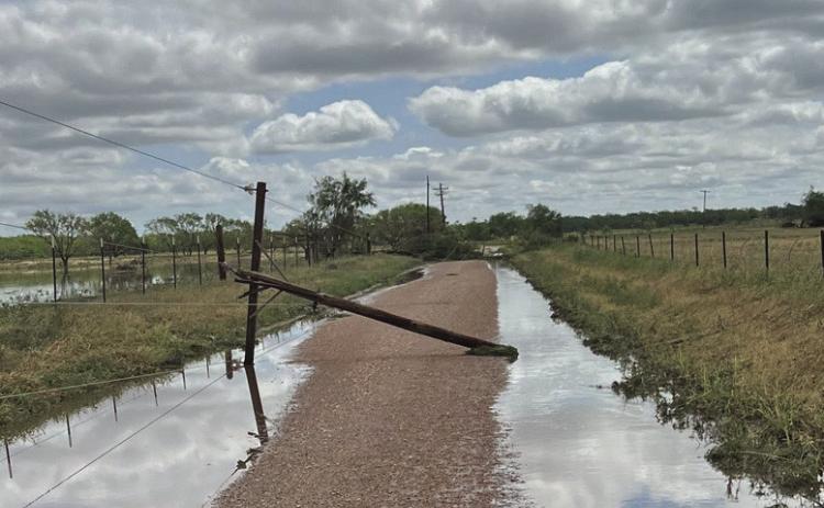 A downed power pole leans across a rural county road, a stark reminder of the storm’s power and the challenges facing utility crews working through mud and water to restore service. Photo courtesy of Big Country Electric