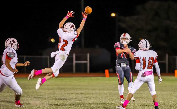 Junior, Gunner Helm, tips a pass from Hornet Quarterback Josiah Coplen