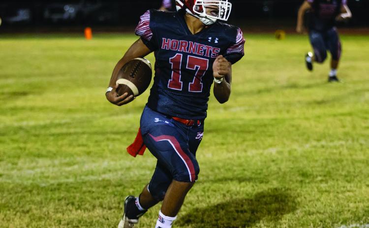 Hornet senior Calob Castaneda races down the sideline towards the endzone during last Friday's win over Guthrie.