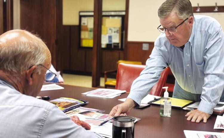 Landowner Brian Snodgrass identifies an alternative location for the proposed Crusoe data center for Commissioner Gary Myers during the May 26 meeting.. PHOTO BY JEFF HURT