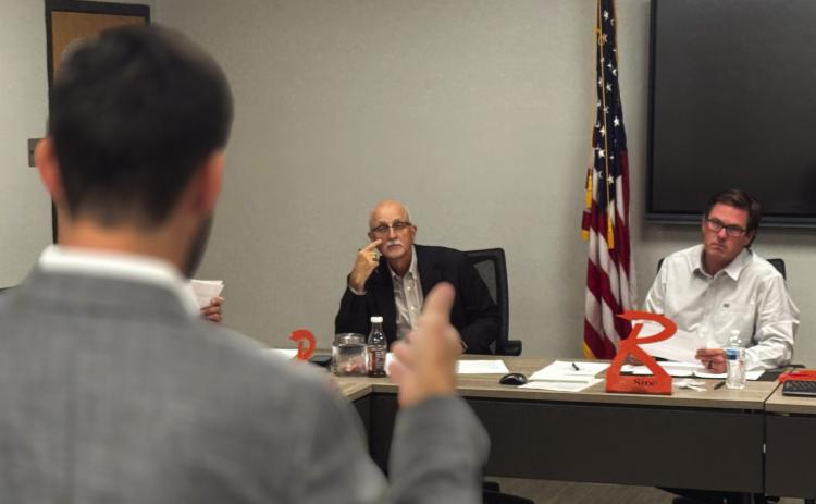 Rotan ISD interim superintendent Dr. Burks board president Britt Sipe follow along as financial advisor Jake Lawrence the presents results of the school district’s bond sale.