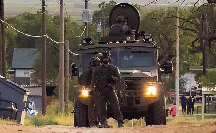 Heavily armed SWAT personnel and an armored vehicle move into position during a standoff in Rotan on Monday, August 11. Tactical units assisted local law enforcement in the safe apprehension of a barricaded suspect on East 7th Street.