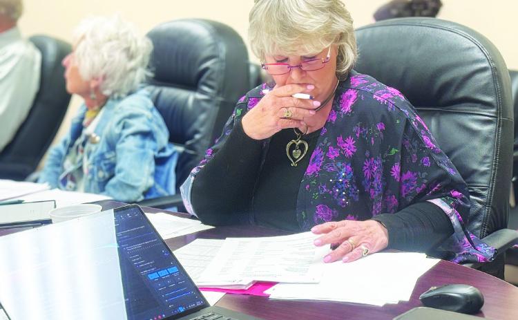 SMHD Board President Ellen Abernathy reviews information regarding the tax abatement application regarding the proposed data center from Crusoe, a major AI developer operating in the region. PHOTO BY JEFF HURT