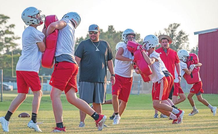 Roby CISD Coaches Johnny Sanchez(Left) and AD Matt Tarbutton(right) observe players' technique during a contact drill.