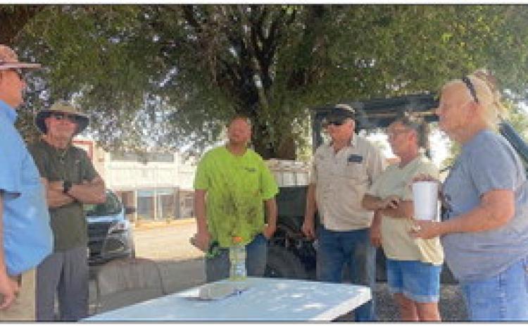 Rory Burroughs (pictured far left) coordinates with a group of Rotan volunteers that were kind to answer a call for help, lending their hands and equipment to remove debris from 12 properties on Tuesday.