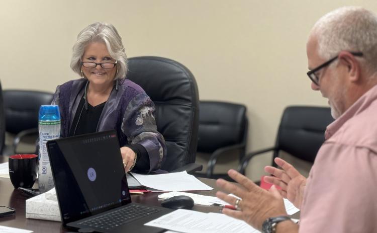 SMHD Board President Ellen Abernathy smiles with approval as CEO Michael Moorhead explains the final version of the district’s tuition reimbursement program, one Abernathy said she is excited for the hospital to put into action.