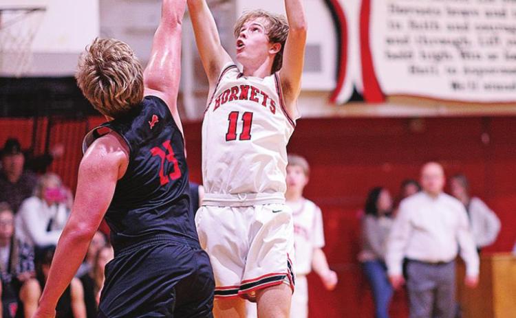 Aspermont's Olen Johnson shoots high over Roby's Eric Ragan. Photo by: Tricia Hurt