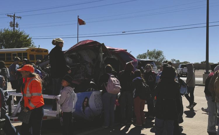Jen Blessing shares the story of her daughter, Aspen, who was killed by a drunk driver in March 2024, as Aspermont ISD students gather around Aspen’s crashed vehicle, displayed by TxDOT to raise awareness about the consequences of impaired driving.