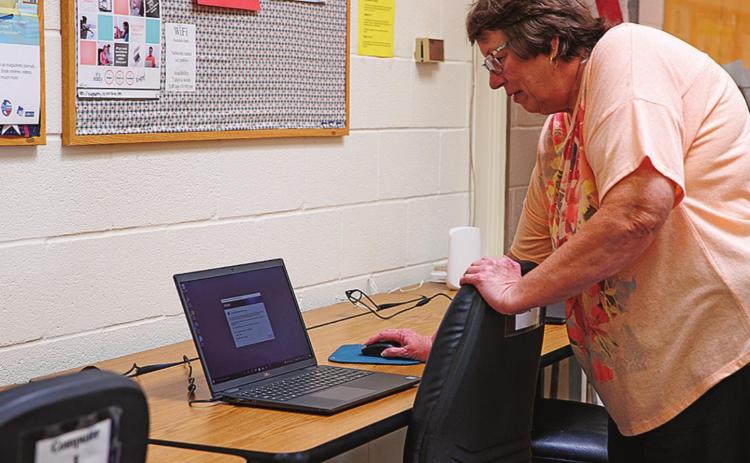 Stonewall County Librarian Kathy Boyles, shows off one of the new laptop computers that the library was able to purchase through the Texas Supports Libraries Grant during the Open House Monday morning.