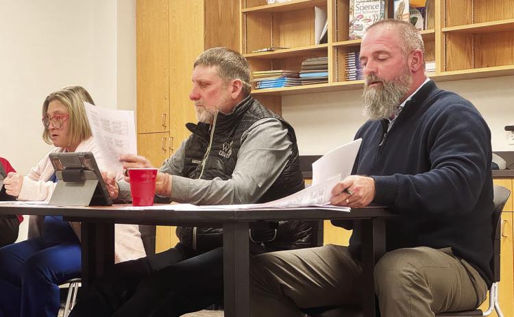 AISD Superintendent Zach Morris and trustees Jennifer Hodges and Ray Bradley review SB 11, which resolves the district to adopt a period of daily prayer, which officials say is unnecessary since the district already supports the expression of faith. JEFF HURT