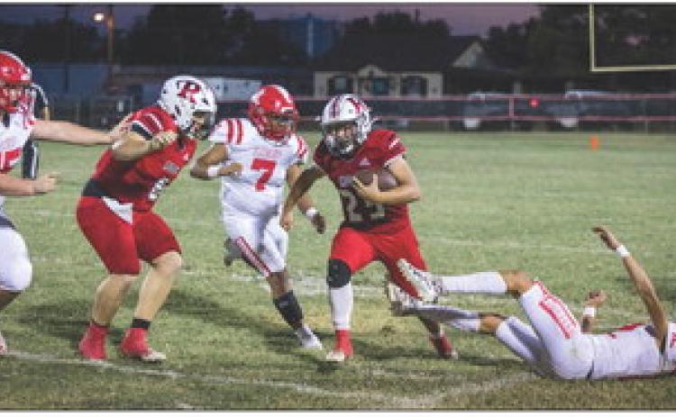 Roby Sophomore Rhylon Lester fights through Longhorn defenders during the Lions' 0-27 loss to Loop last Thursday night. PHOTO BY MARK MARTINEZ