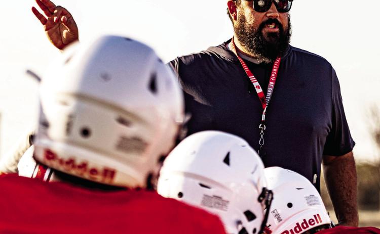 Zane Graves, newly appointed principal of Roby High School, speaks to student-athletes during football practice. Graves, known for his servantleadership style and deep roots in the district, now transitions from the field to the front office to lead the entire campus. PHOTO MARK MARTINEZ