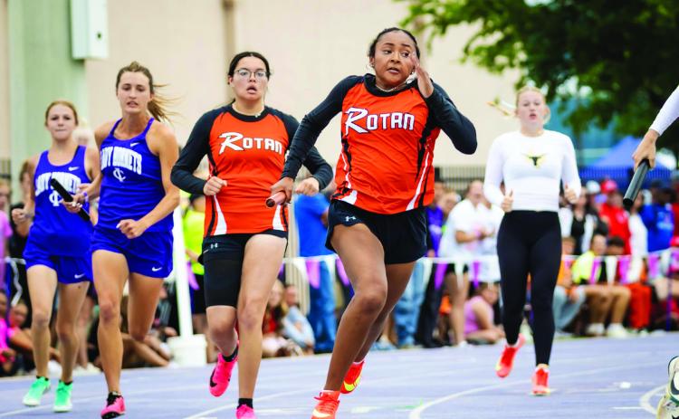 Rotan's Belle Turner recieves the hand off from teammate Braylee Carrillo in the girl's sprint relay. The Lady Hammer sprint relay team of Avery Gonzalez, Braylee Carrillo, Belle Turner, Talyn Lewis, &amp; alternate Kate Van Poppel, qualified as a wildcard entry for the State Meet after achieving the fastest 3rd place time in all four Regions. Photo by: Mark Martinez