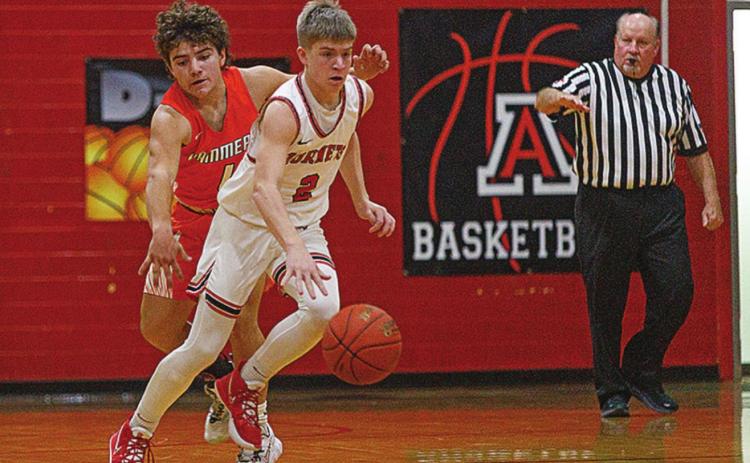 Hornet Keltyn VanMeter slips by Rotan's Zac Flores during last Friday's win over the Hammers. Photo by: Mark Martinez