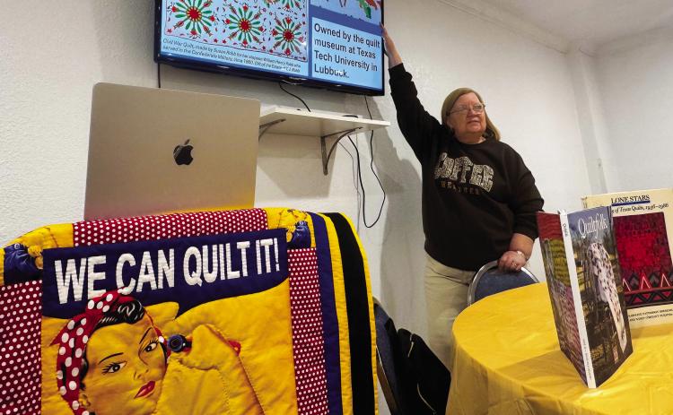 During her presentation, Ellen Goodwin points to a Civil War-era quilt made by Susan Robb for her stepson, William Henry Robb, who served in the Confederate Army. The quilt is now housed at the quilt museum at Texas Tech University. PHOTO BY JEFF HURT