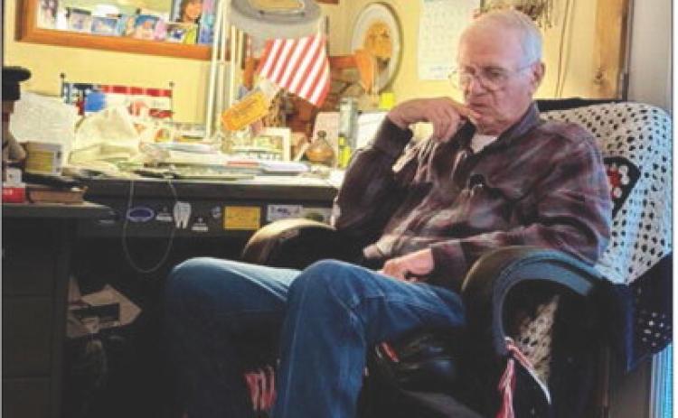 Vietnam veteran Sgt. Leonard Haag reflects at his desk in his Stonewall County home. His medals line the wall, but what he treasures most are the photos and handmade gifts from his grandchildren.