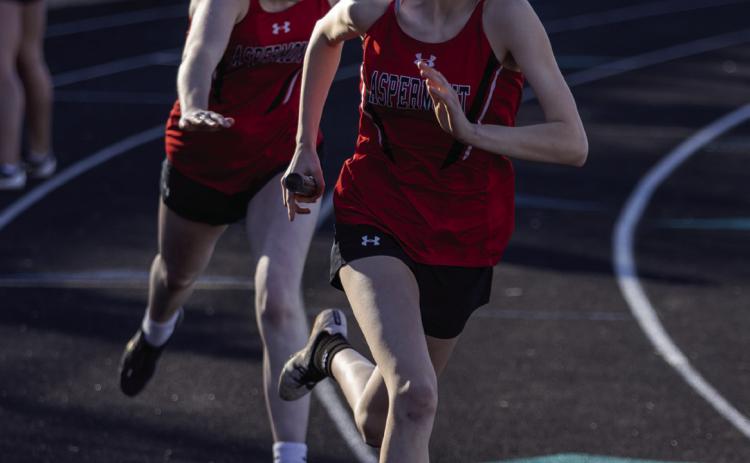 Aspermont's Ashlyn Holson recieving the handoff from teammate Matti Polk in the 4x200m relay. (PHOTO BY MARK MARTINEZ)