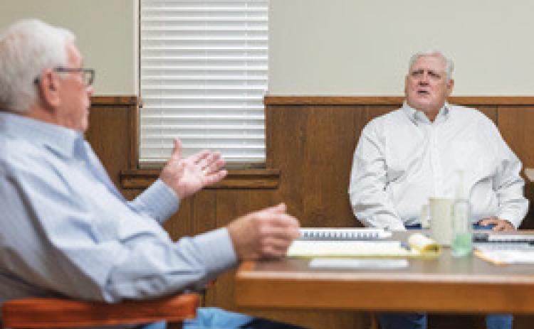 Judge Ronnie Moorehead speaks with Attorney James Payne during the October 13 commissioners court meeting where officials unanimously voted in favor of appointing Payne to fill the vacant Stonewall County Attorney's office.