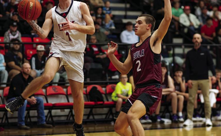 Roby senior Dallas Shumaker looks for an open man before jumping out of bounds. Photo by: Mark Martinez
