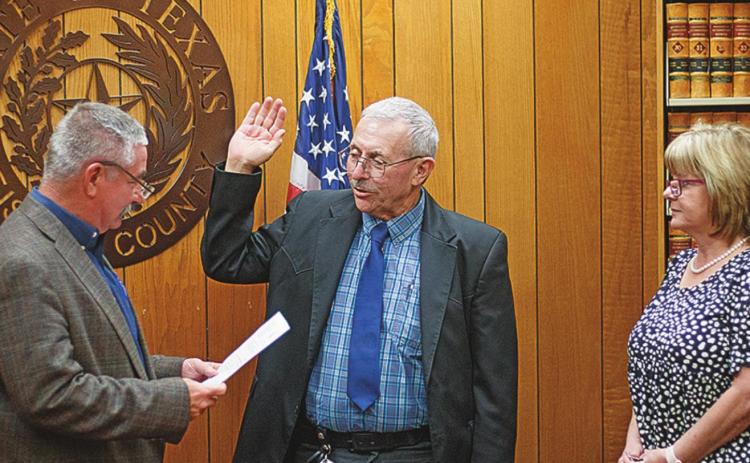 Teressa Ford looks on as Judge Ken Holt swears in her husband, Randy Ford, as the new Fisher County Sheriff Monday afternoon.
