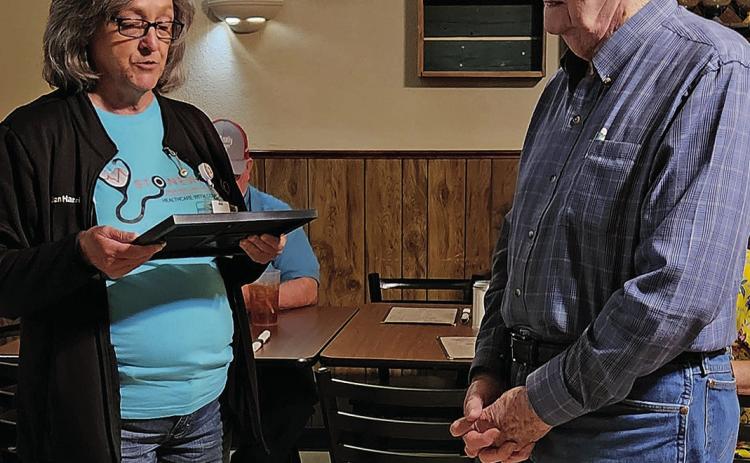 Stonewall Commissioner Jan Harris presents Dean McAnnally with a Proclamation declaring his birthday, August 10th as Dean McAnnally Day in Stonewall County.